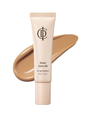 A squeeze tube of ICD sheer glow BB cream in shade 23 Light Medium, shown upright with a matching beige makeup smear behind it on a white background.