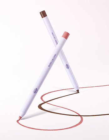 Two lip liner pencils crossed in an X shape on a white background, one showing a brown tip and the other a pink tip, with both shades drawn in squiggle lines below.